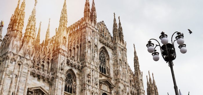 Beautiful Panoramic view of Duomo square in Milan with big street lamp. Italy.